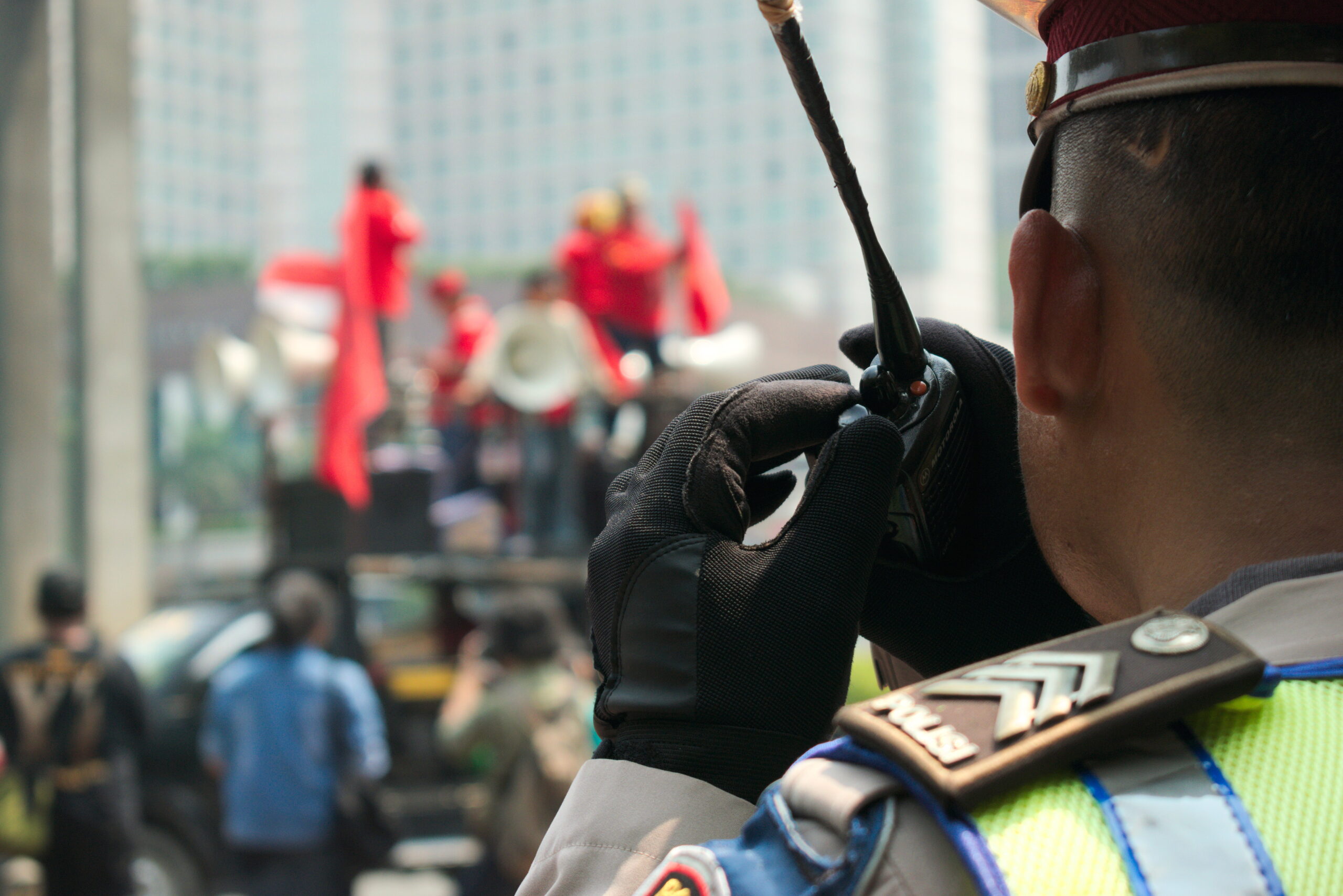 close-up-police-man-using-walkie-talkie-city