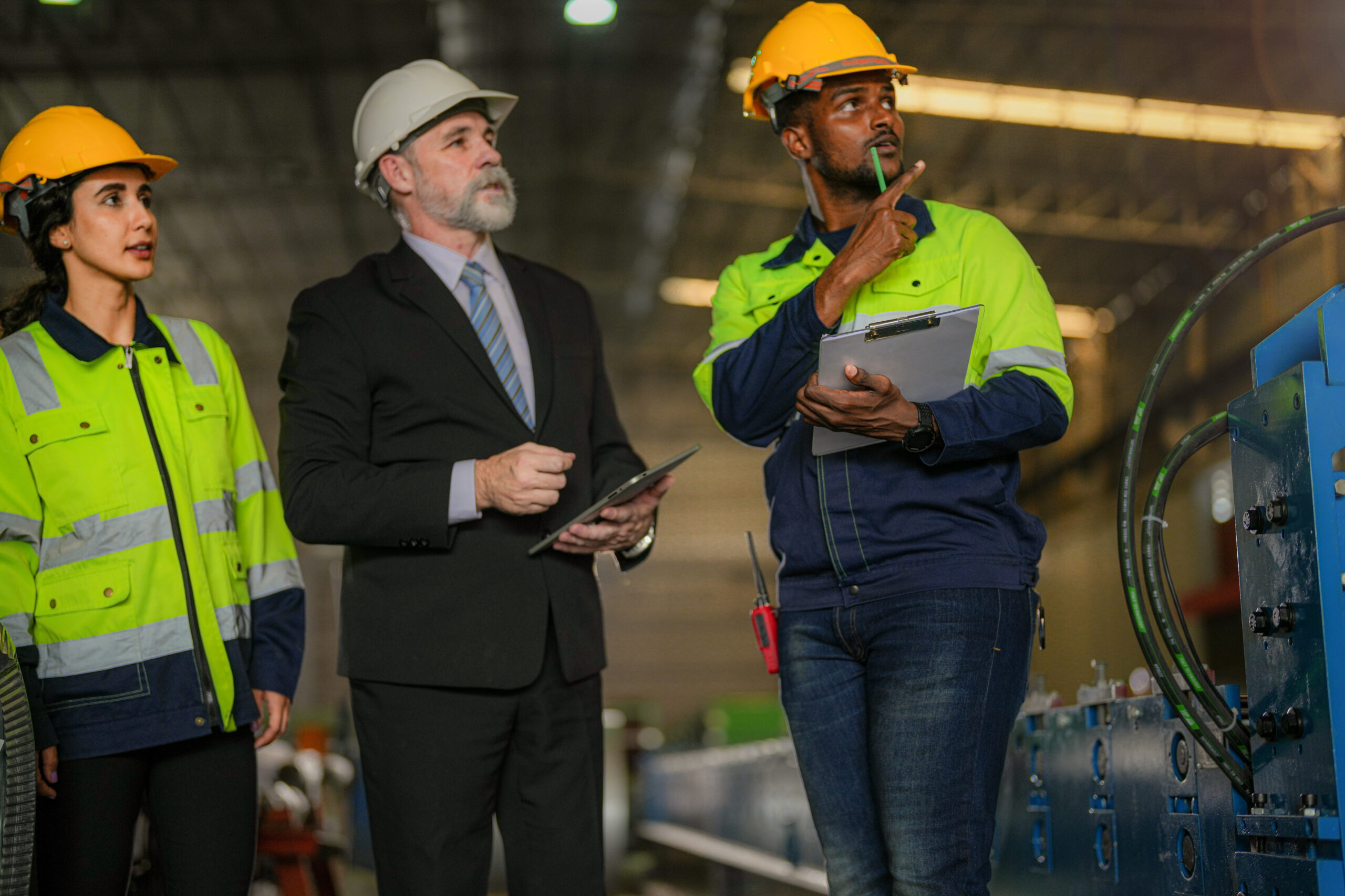 team of engineers checking control heavy machine in factory. Sen