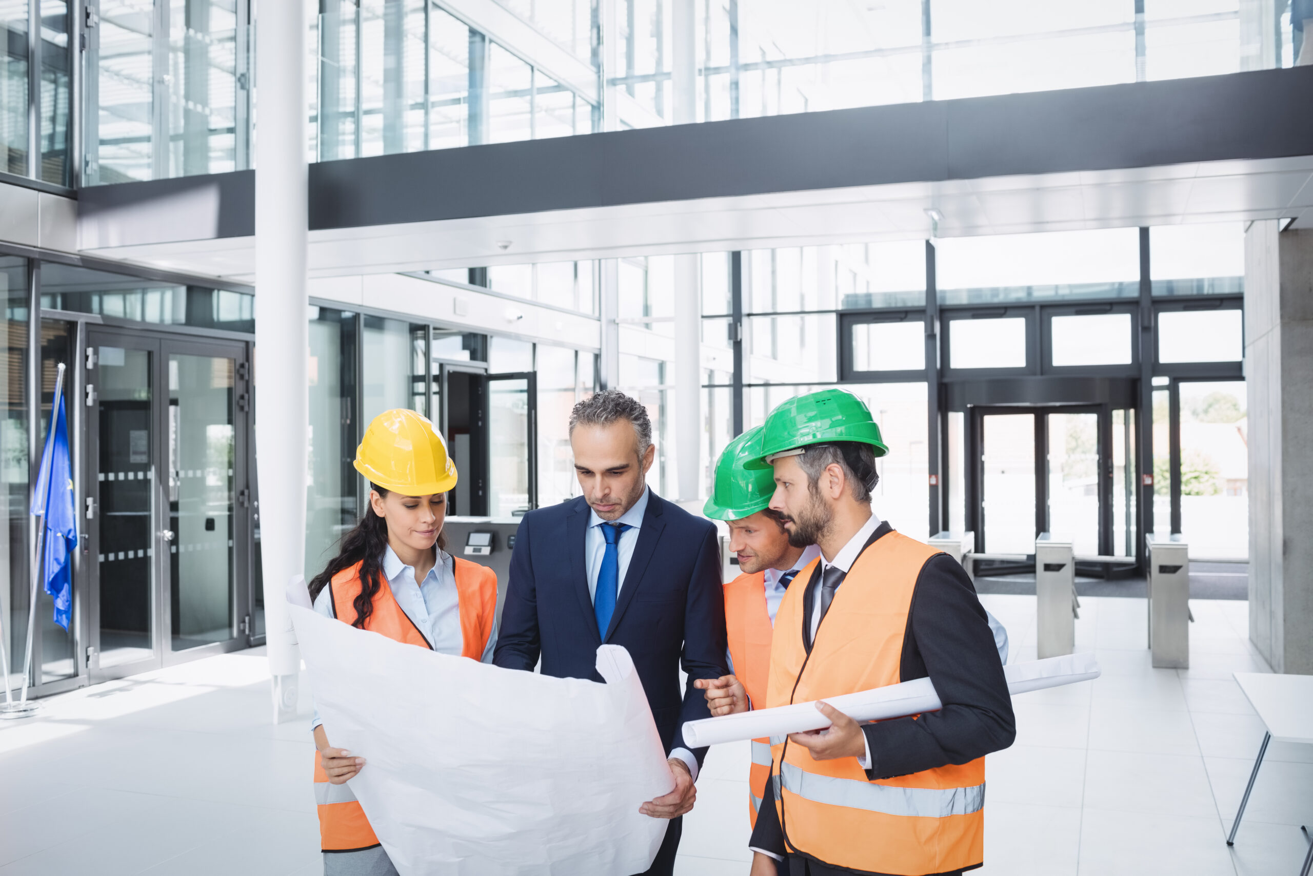 Businessman discussing on blueprint with architects in office building